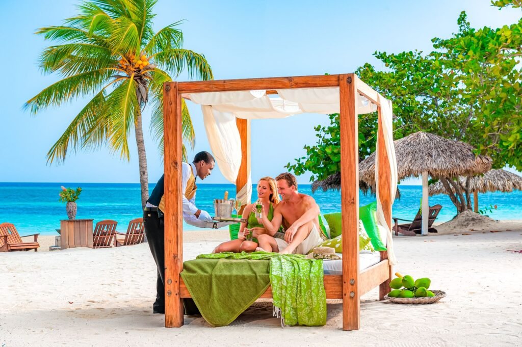 Couple relaxing on the beach at a Sandals resort booked through a Nashville travel agent
